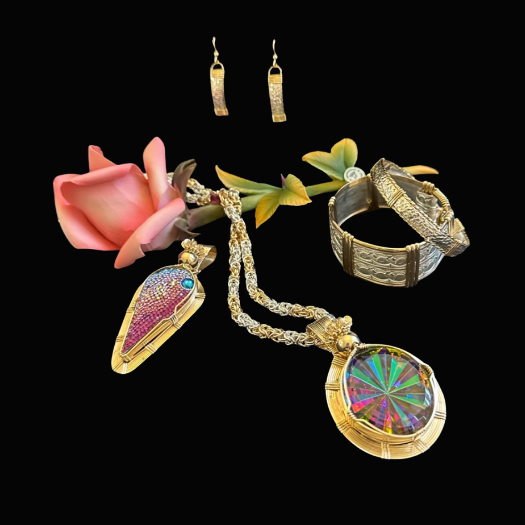 Gold jewelry including earrings, a necklace with a large multicolored gemstone, a bracelet, and two-tone earrings, arranged with a pink flower and green leaves against a black background.
