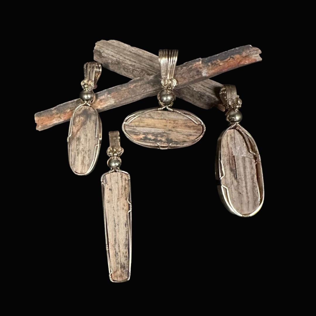 Jewelry set with silver bands and wooden stones, including earrings and a pendant, displayed against a black background.