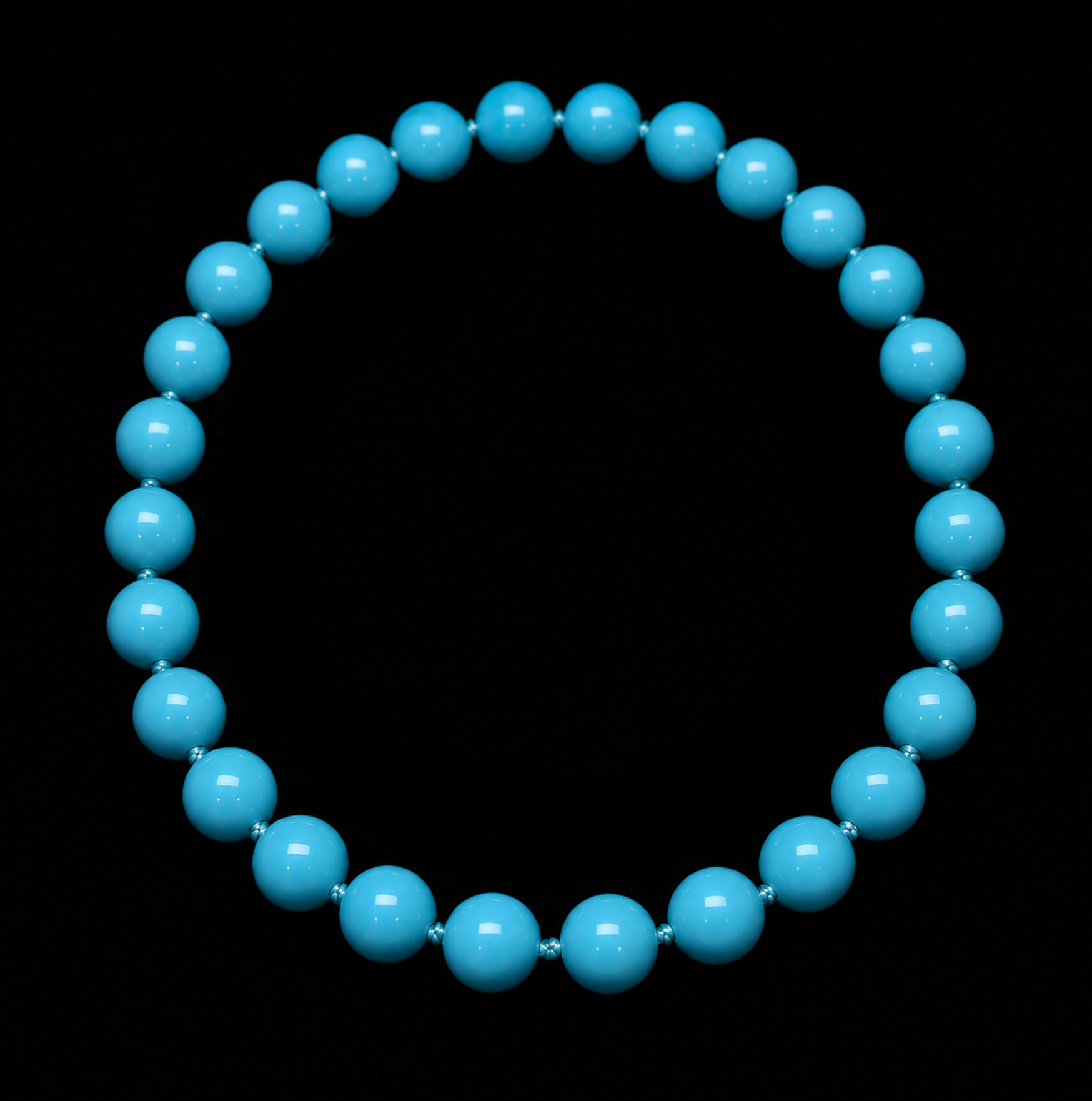 A string of blue beads forming a circular shape on a black background.