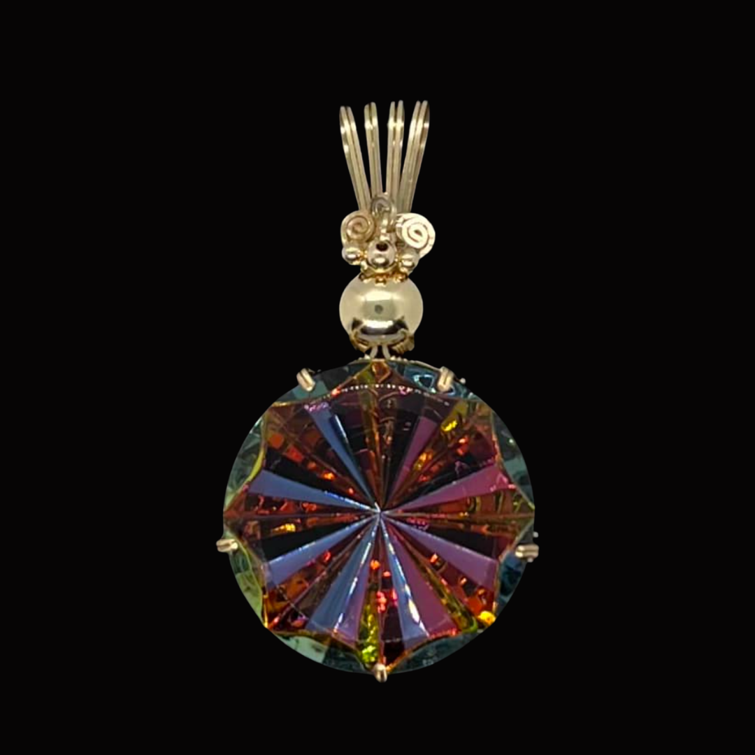 A glass pendant hanging from a decorative metal bail.