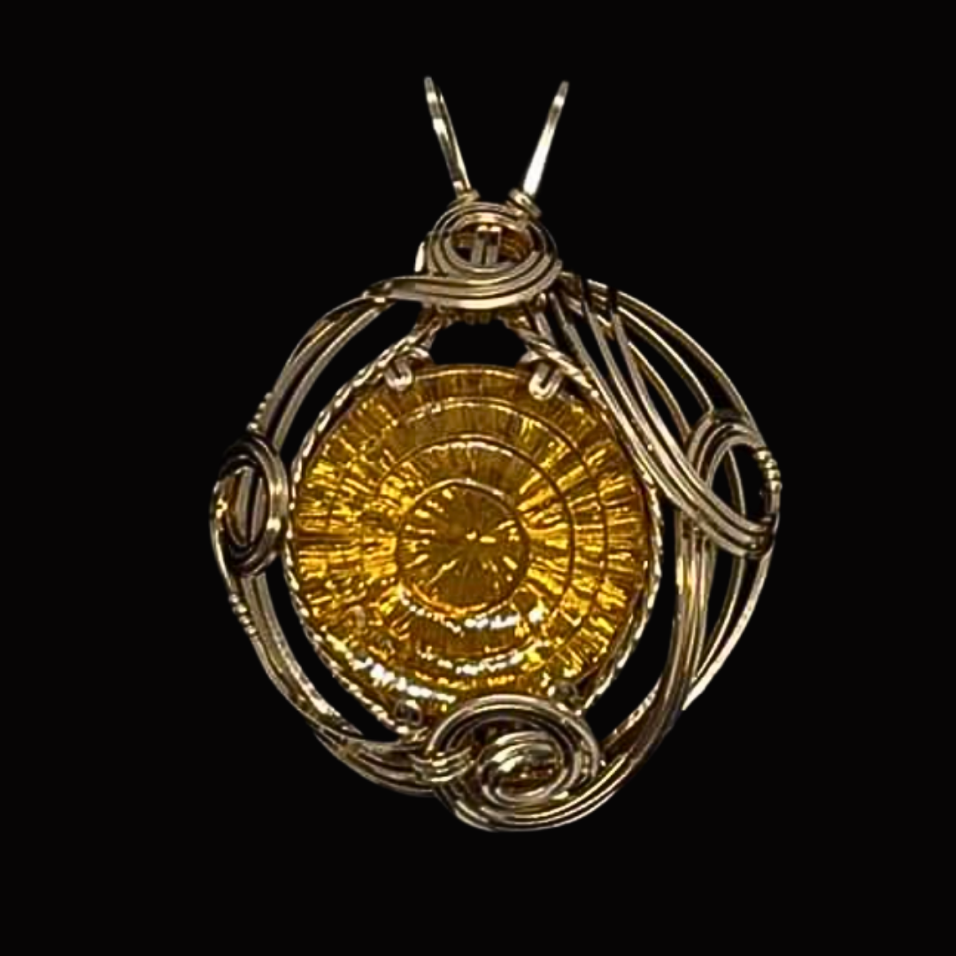 Gold and silver steampunk-style pocket watch pendant with intricate wire wrapping, set against black background.