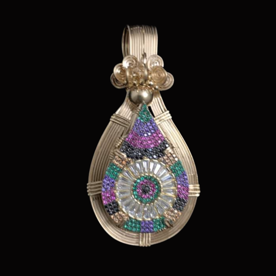 A decorative pendant with a gold frame, featuring colorful gemstones arranged in a spiral pattern, with a purple, pink, green, black, and clear gemstone design on a black background.