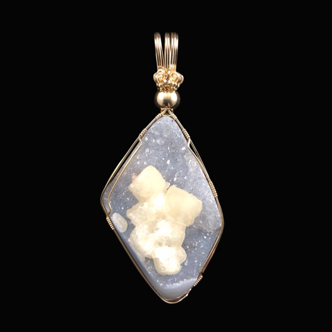 Pendant with a large, irregularly shaped white mineral crystal set in a wire frame, hanging from a decorative gold bail.