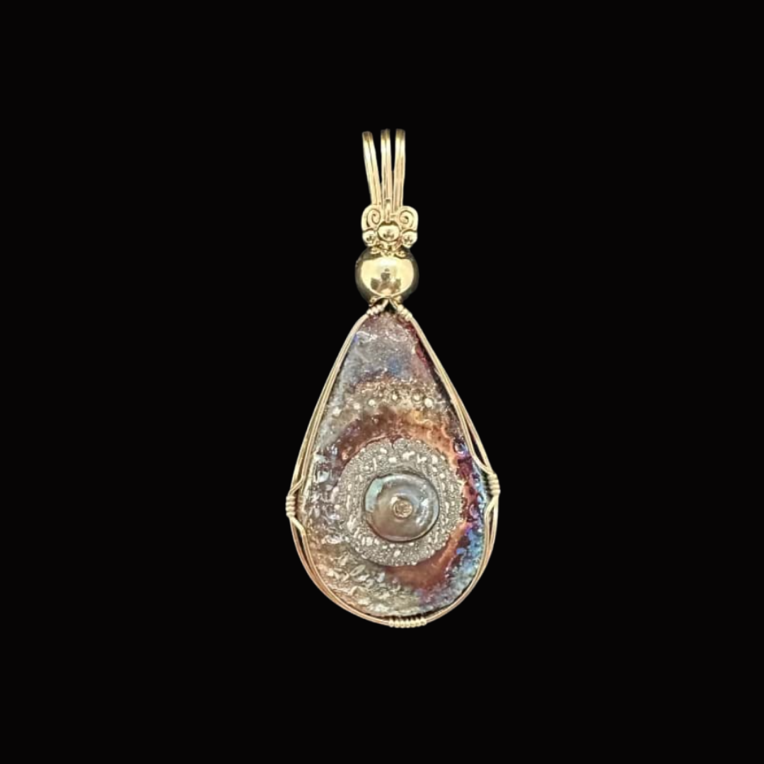 Gold pendant with a large, iridescent shell or gemstone in a teardrop shape, set in a decorative gold frame with intricate wirework and an ornate bail.