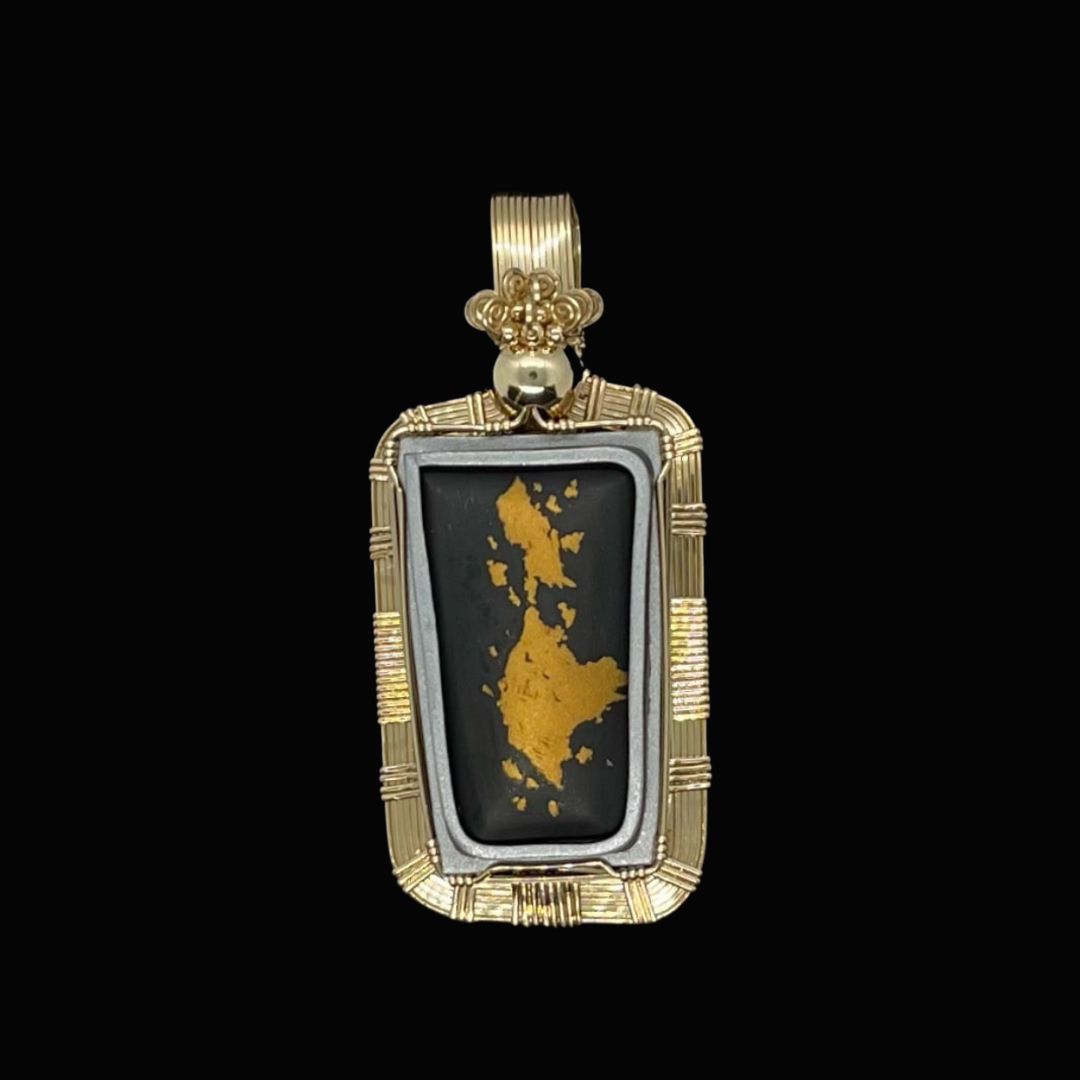 Gold and silver pendant featuring a black background with a gold map of the Philippines, surrounded by gold wire detailing on a black background.