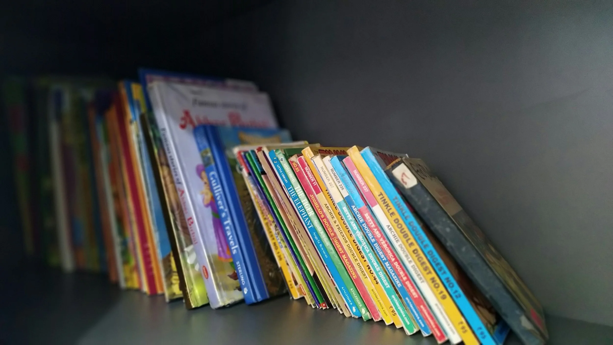 A collection of well-loved children's books on a bookshelf