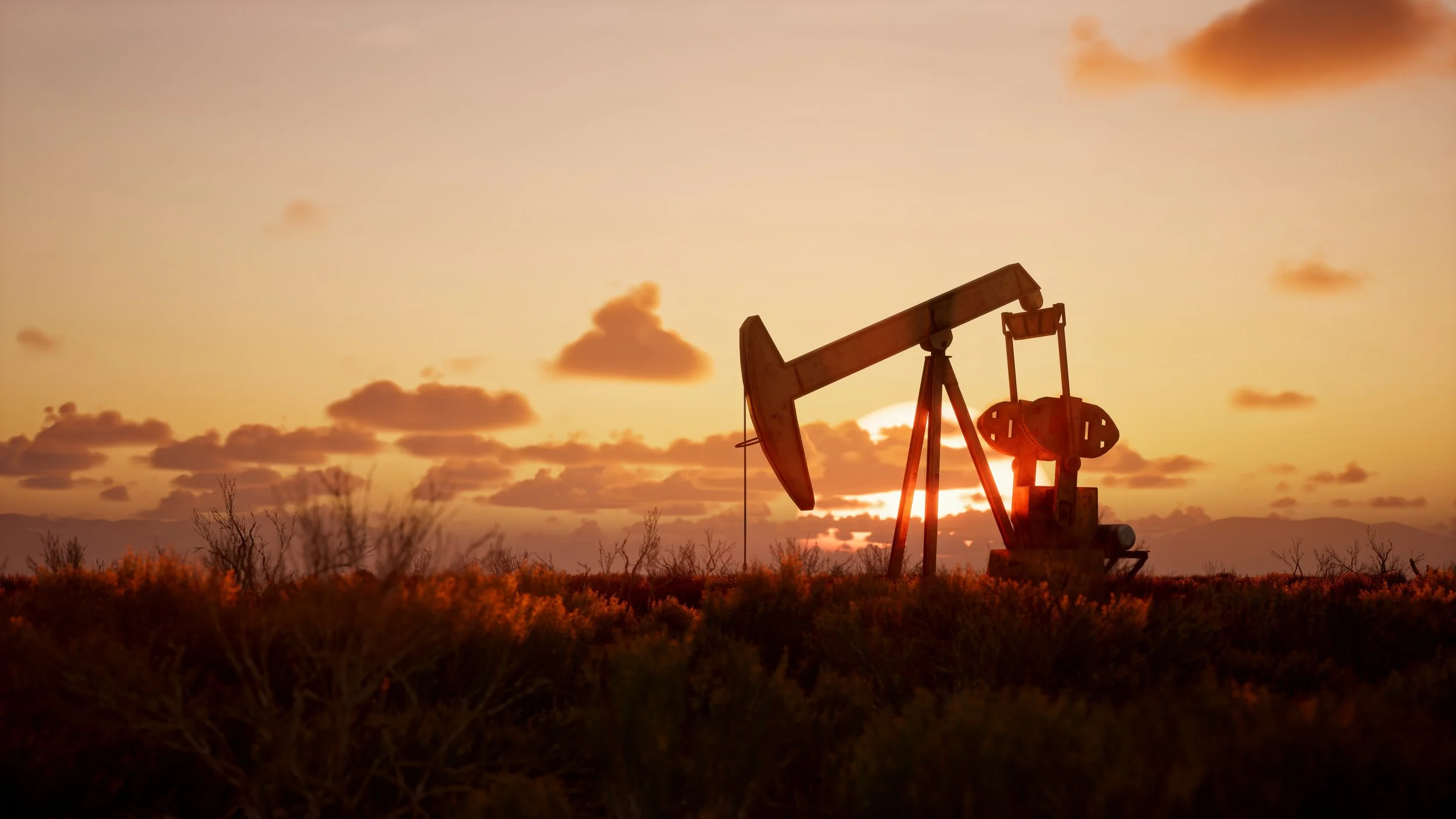 Industrial oil pump at sunset.