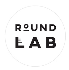 Logo with the words 'ROUND LAB' in black capital letters inside a white circle
