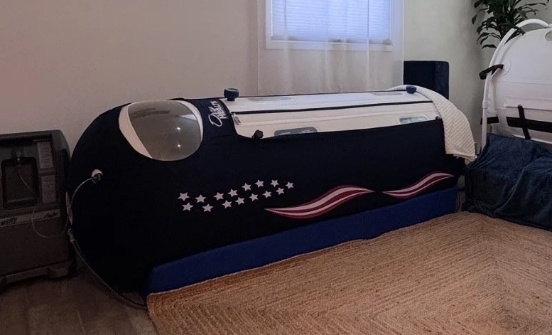 Hyperbaric Oxygen chamber next to a window with curtains.