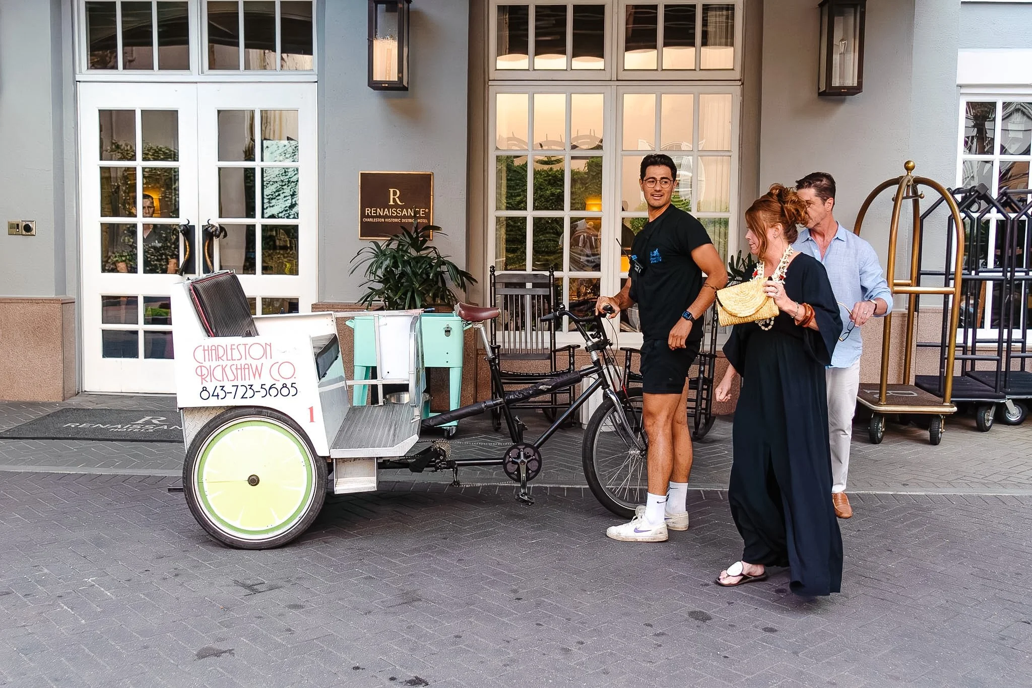 Charleston Rickshaw cart waiting outside a downtown Charleston hotel for guest pickup