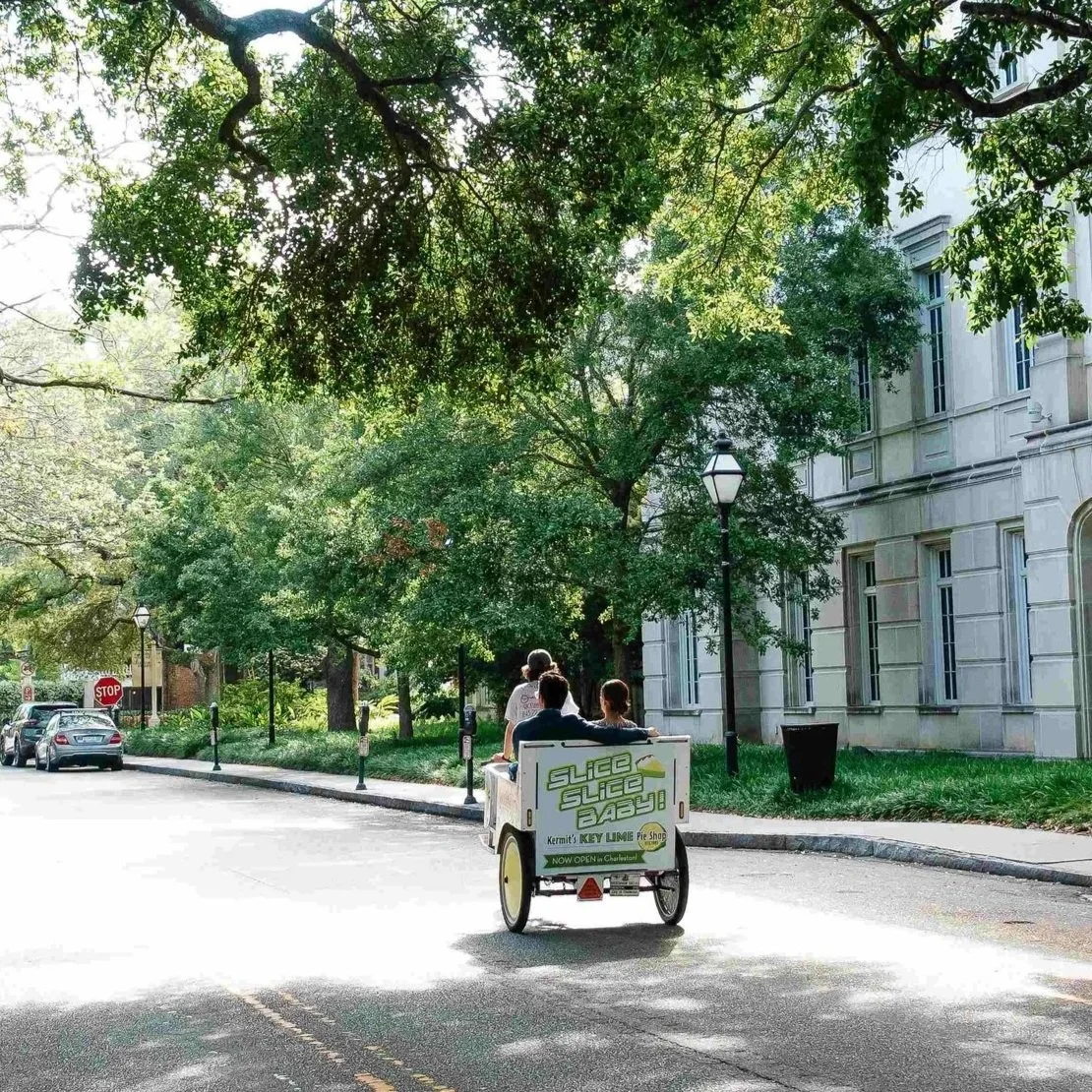 Charleston Rickshaw pedicab advertising a local key lime pie shop on a tree-lined downtown Charleston street