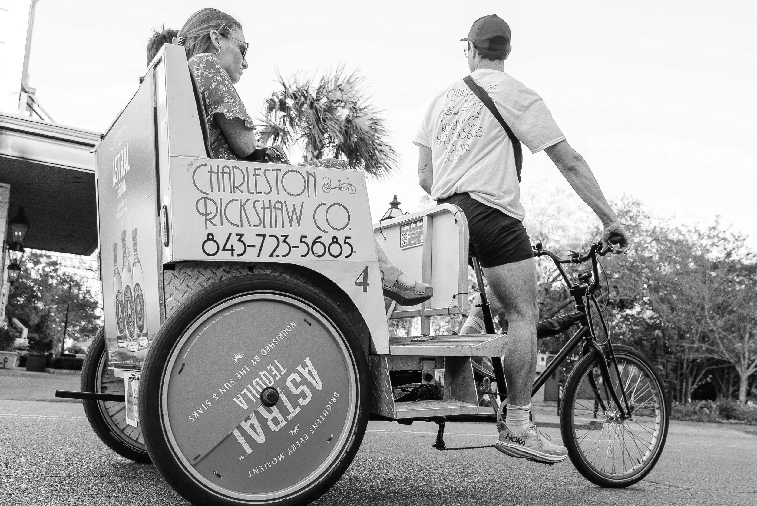 Charleston Rickshaw driver with cargo trailer in a downtown Charleston park, the Holy City's original rickshaw company