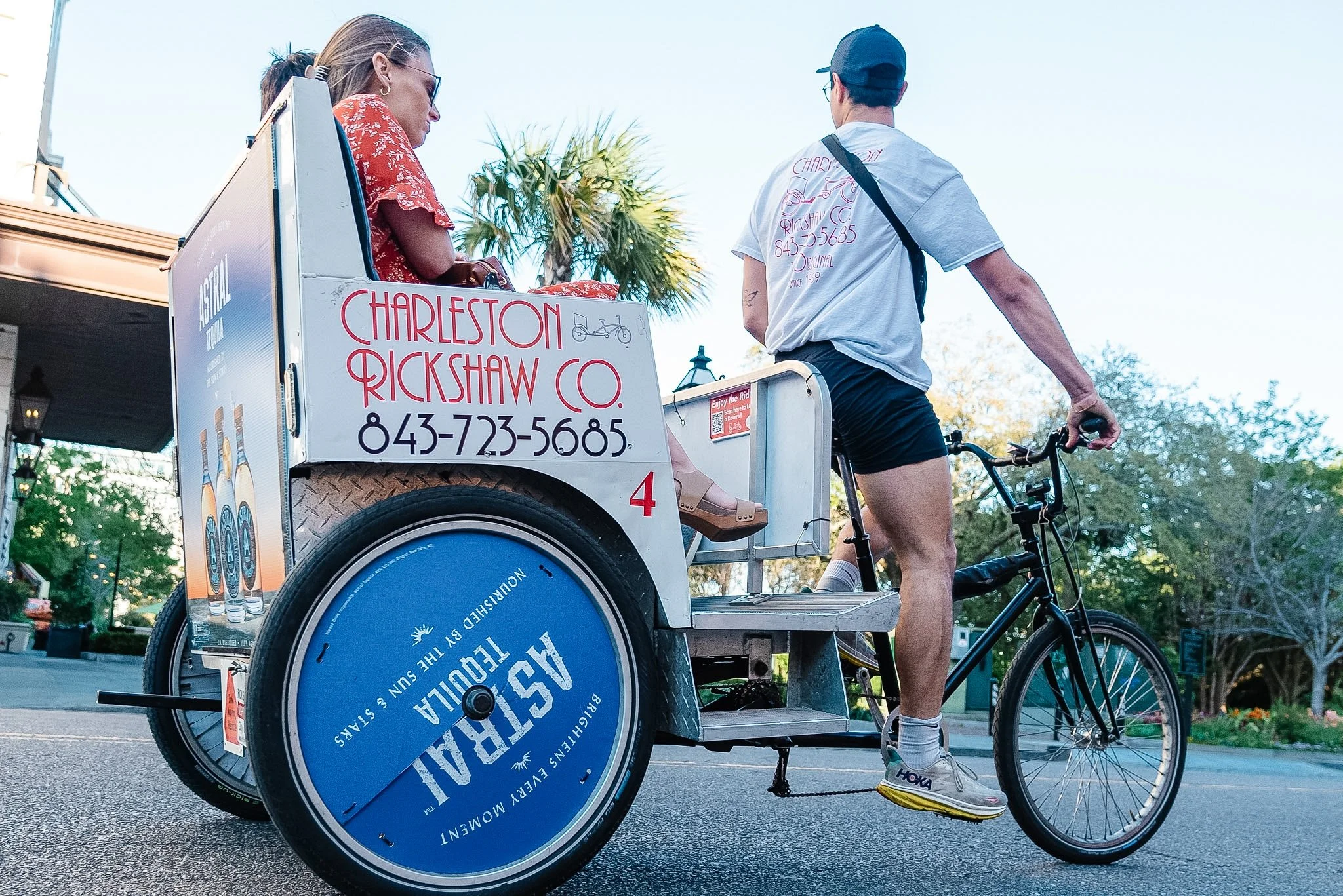Charleston Rickshaw driver giving a downtown Charleston ride to a passenger