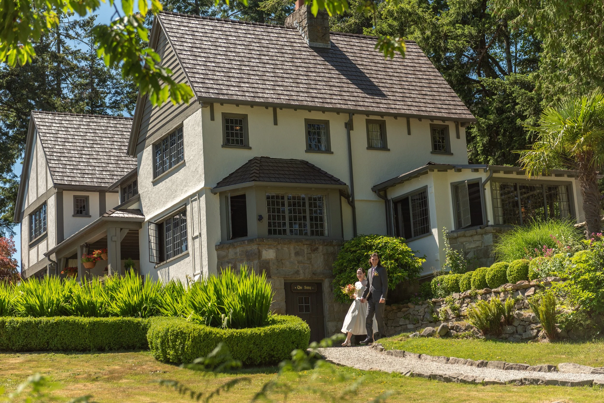 Emily and Yohann walking together during their Hastings House wedding on Salt Spring Island