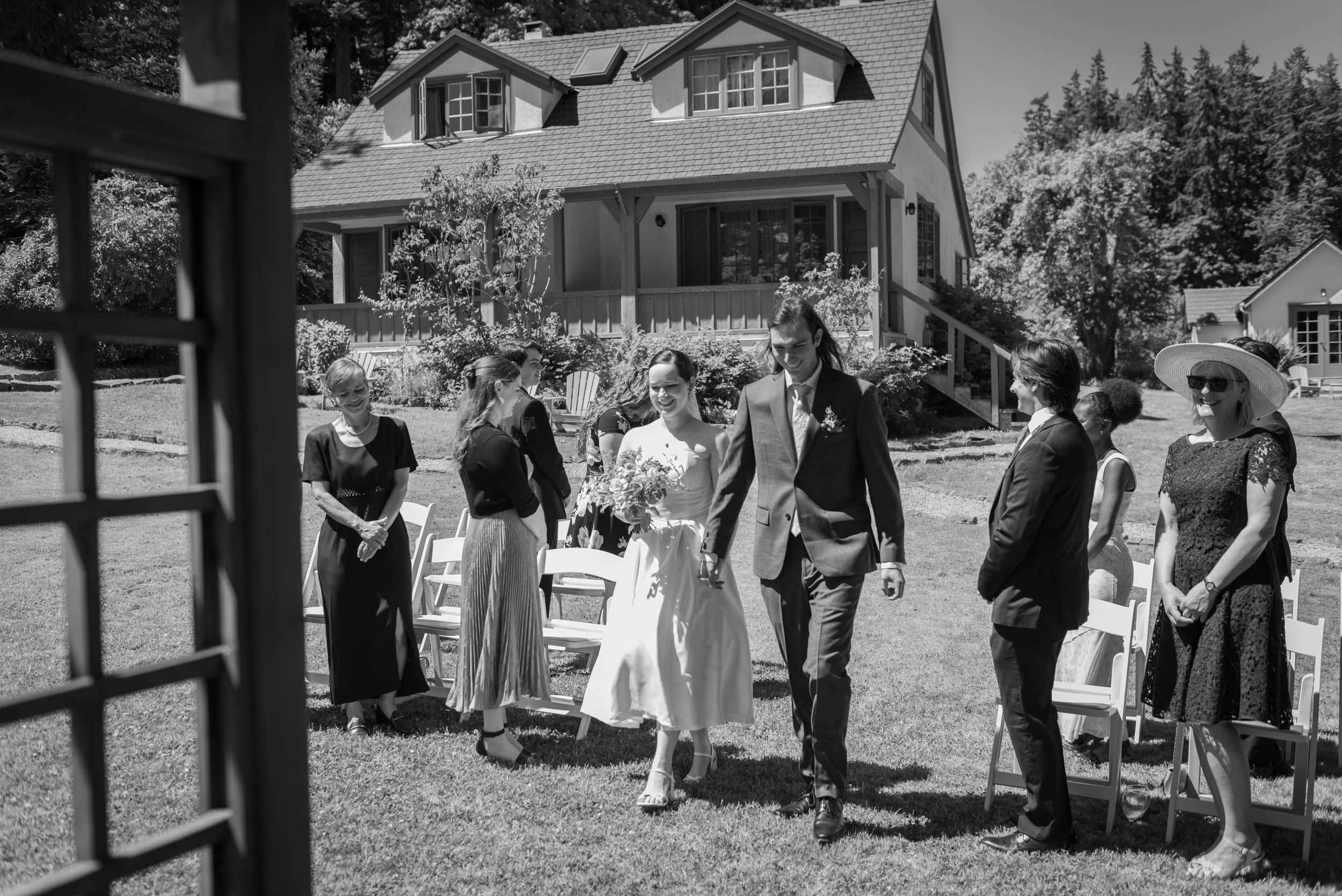 Emily and Yohann walking together during their Hastings House wedding on Salt Spring Island