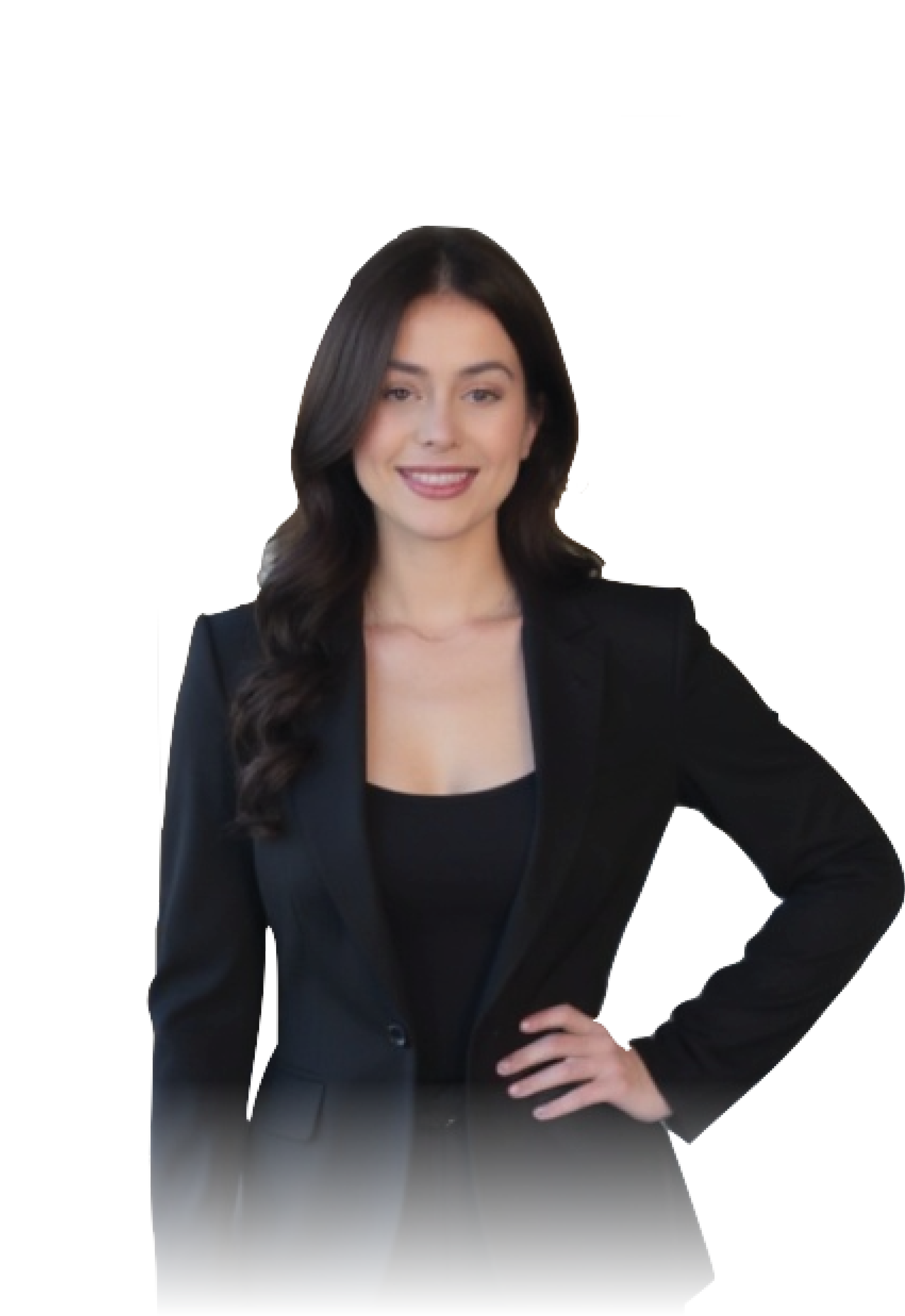 A woman with long dark hair, wearing a black blazer and top, standing with her hand on her hip, smiling against a black background.