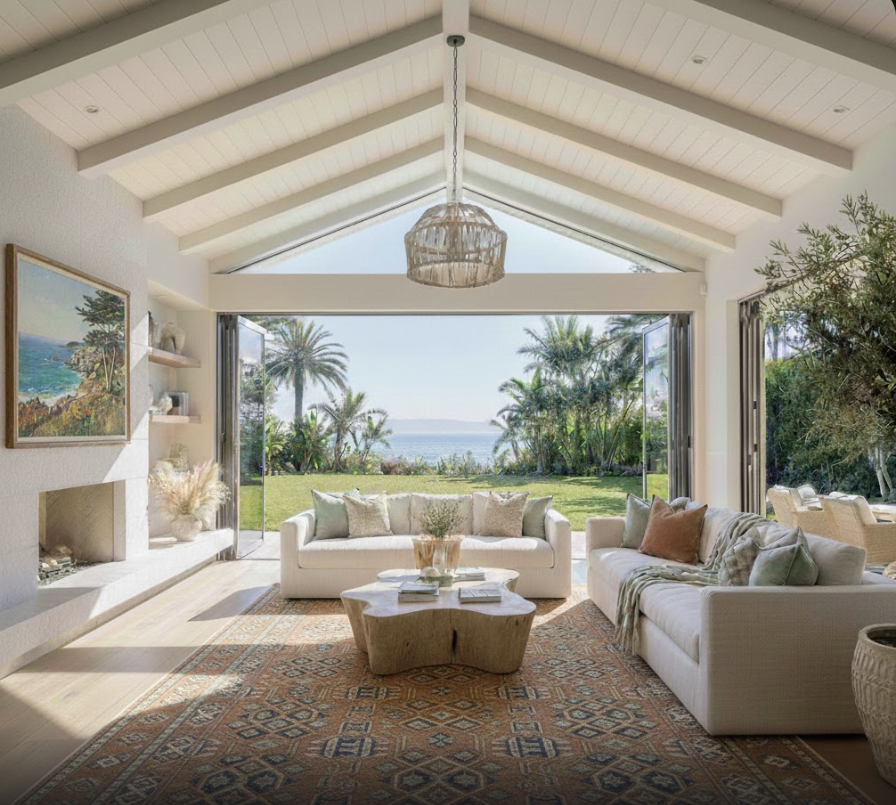Terra Linda mansion living room with vaulted ceiling, white sofas, fireplace, and a view toward the bay.