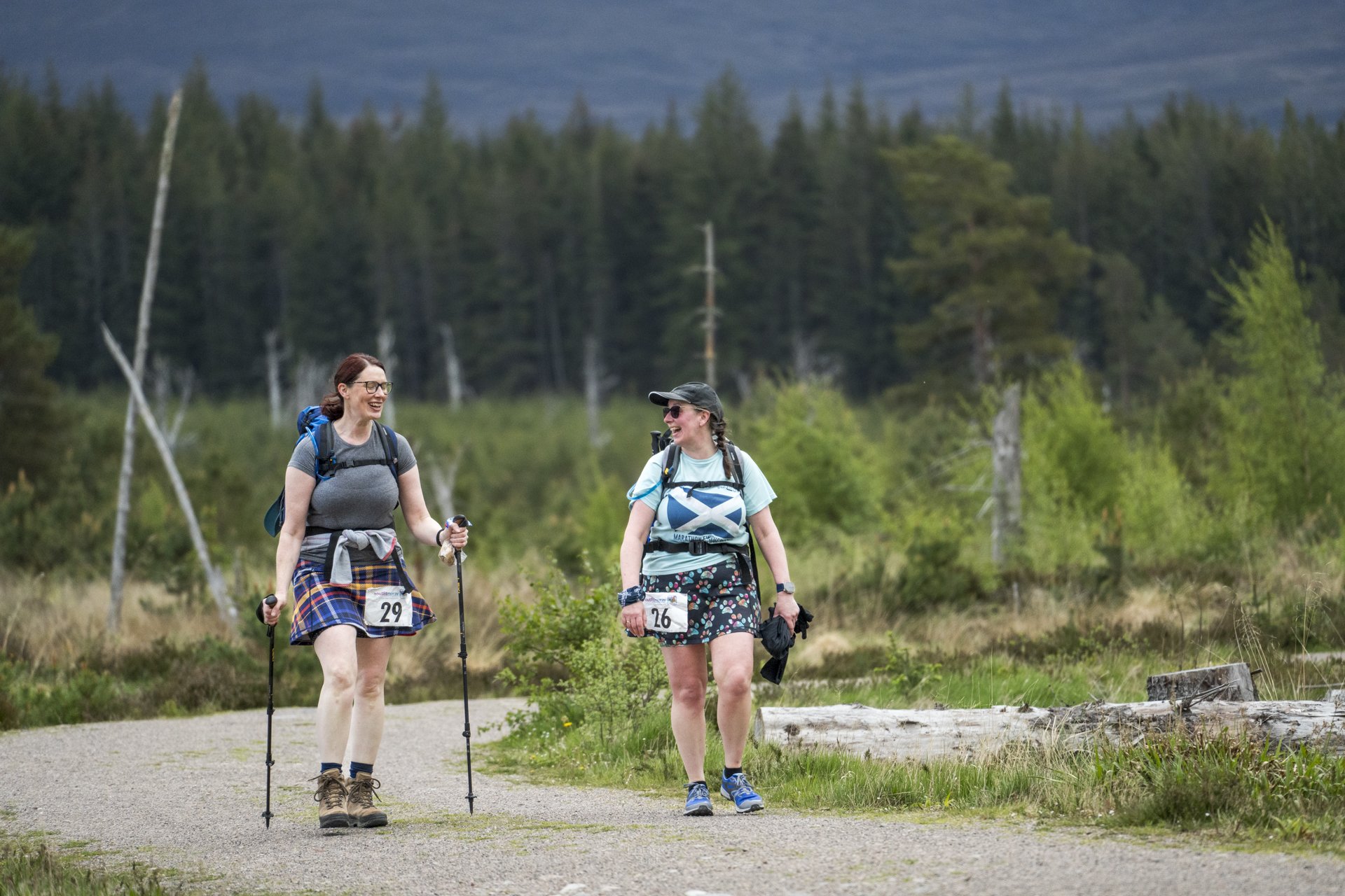Two women live their best lives while hiking outdoors in the Cairngorms National Park. Candid outdoor event photography with local photographer Louise Took.