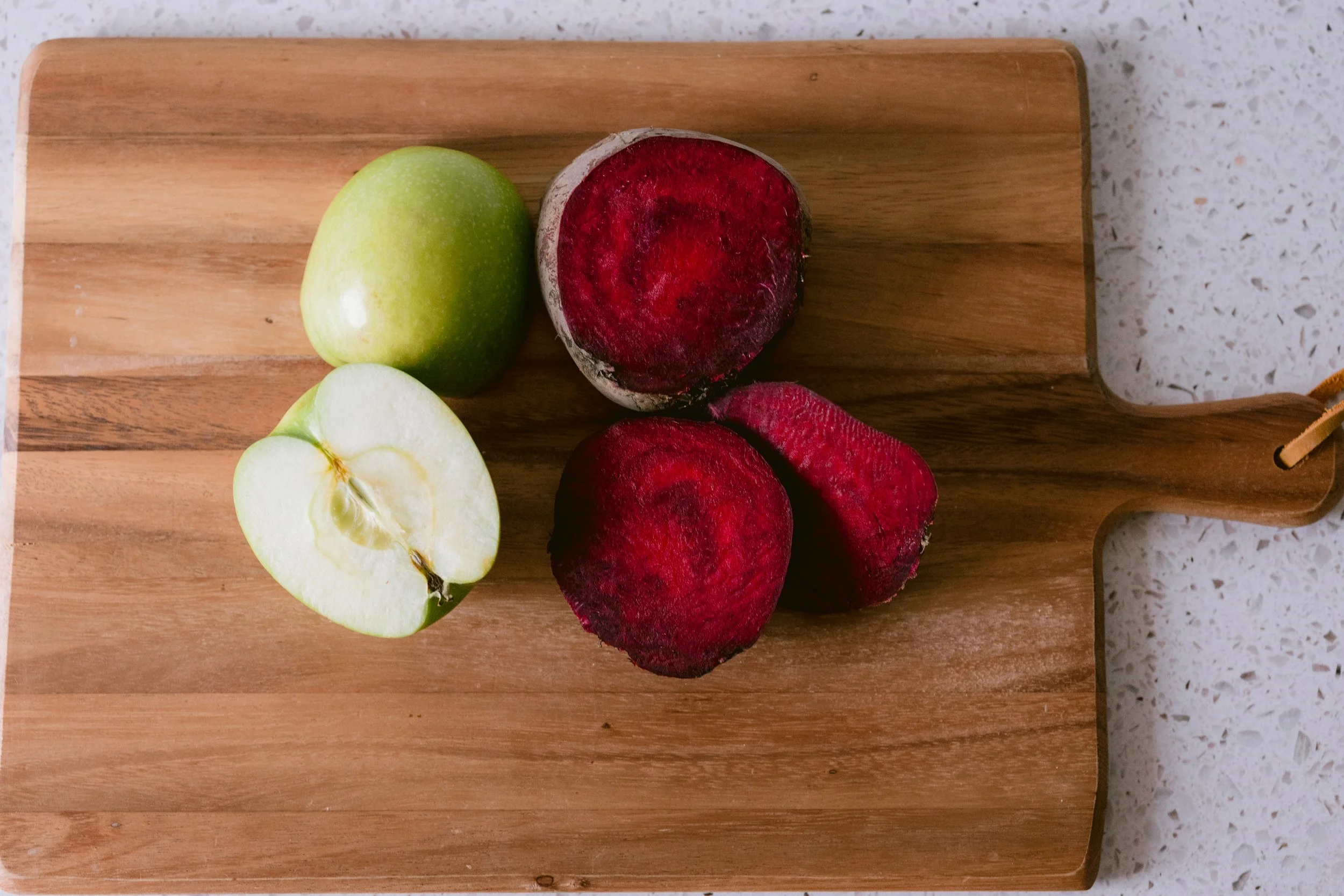 Fresh organic produce — green apple and beet — used in Green Fork & Straw kitchen