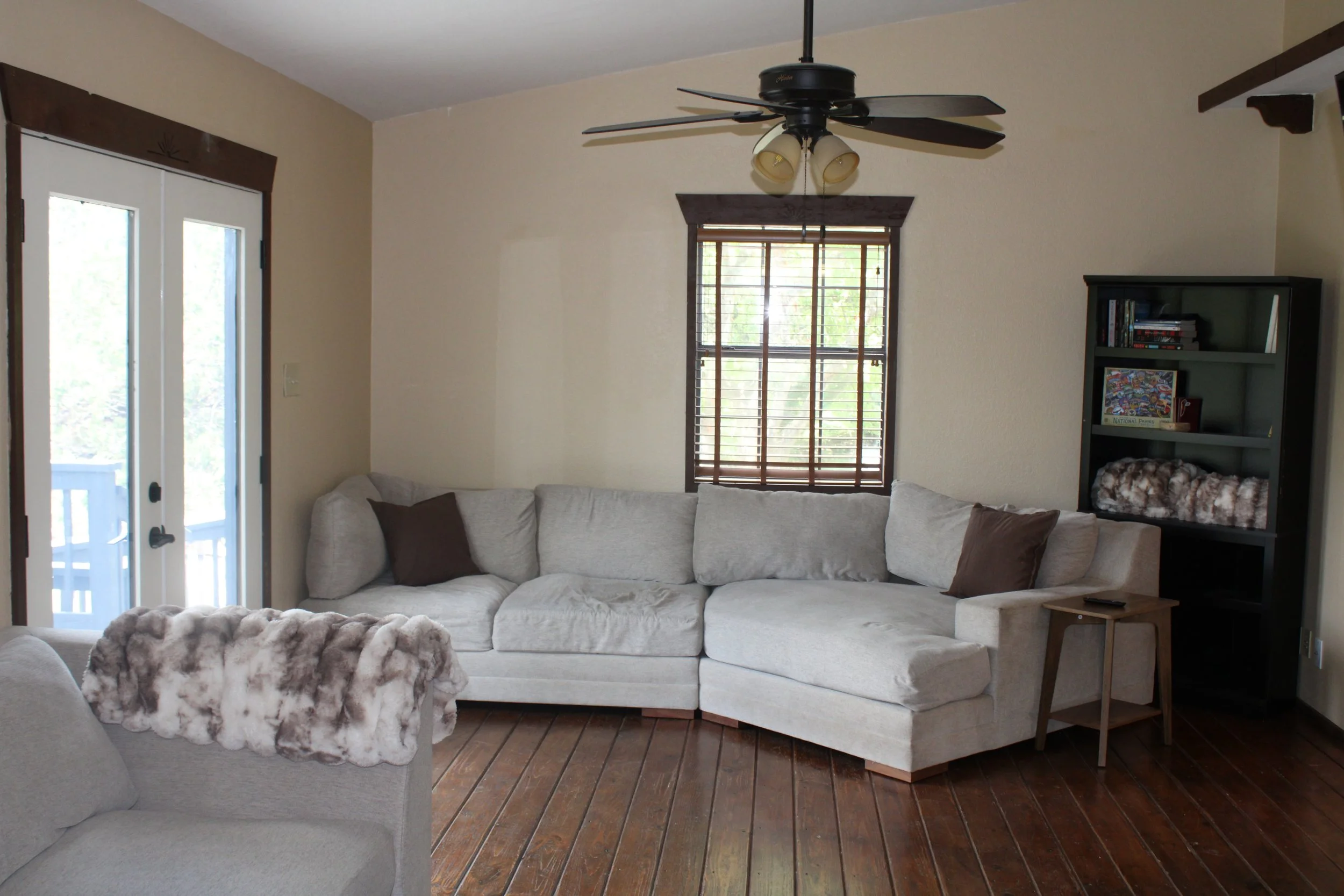 Living room with a sectional sofa, Smart TV, and other seating areas perfect for fellowship