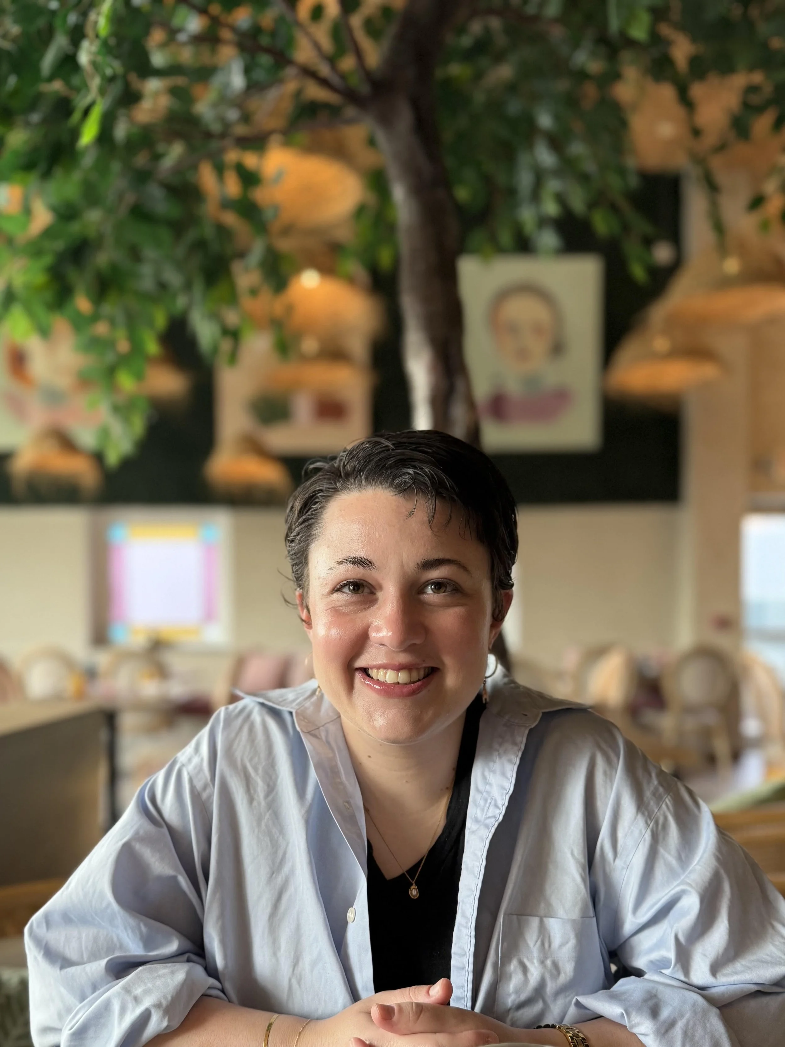 Smiling woman with short dark hair. Virtual therapy for anxious women who have mixed identities, grew up too fast, and wish to feel grounded in themselves throughout New York State.