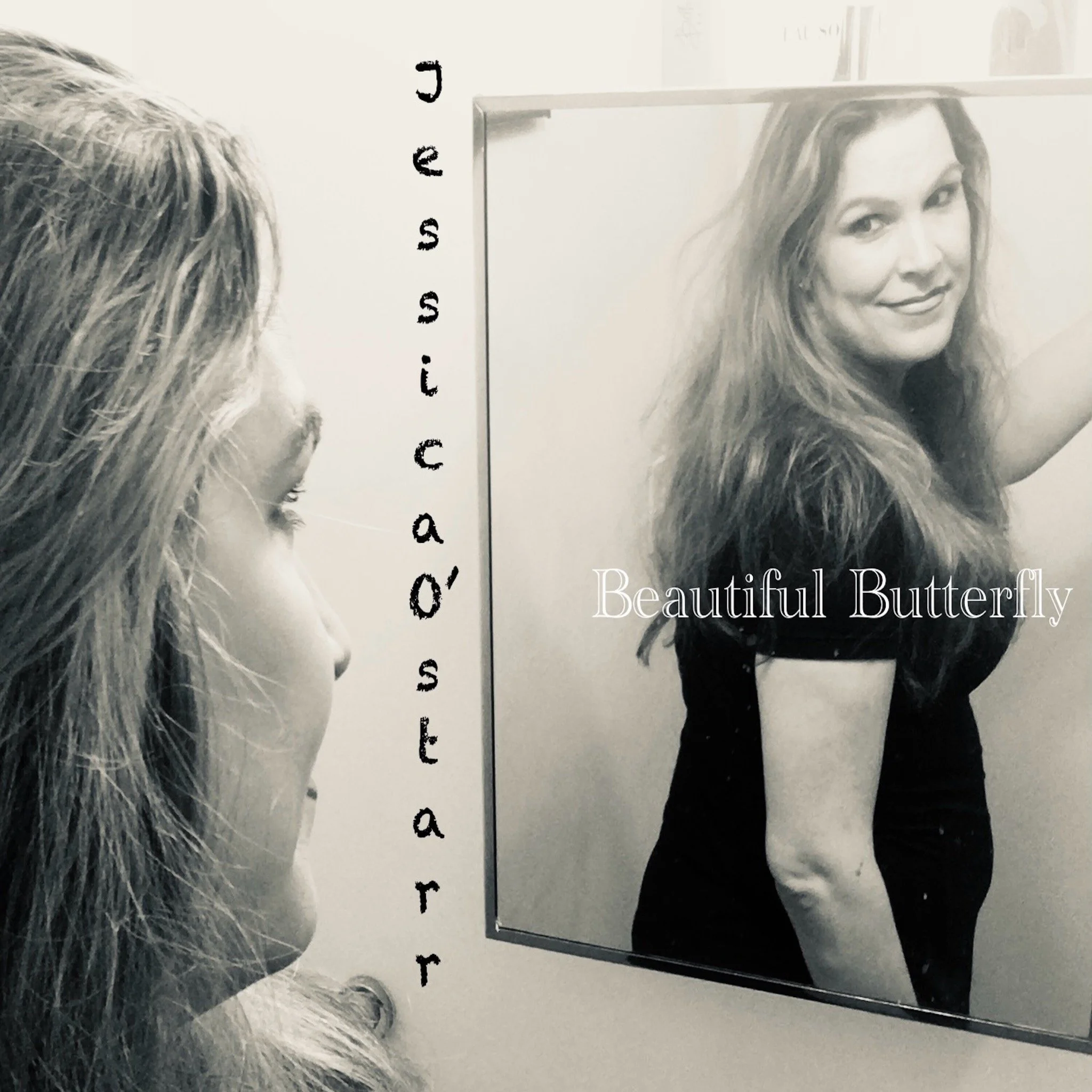 A mirror reflecting a woman with long wavy hair smiling and wearing a black dress, with a partial view of a person with gray hair in the foreground, and USB flash drives lined up vertically on the wall.