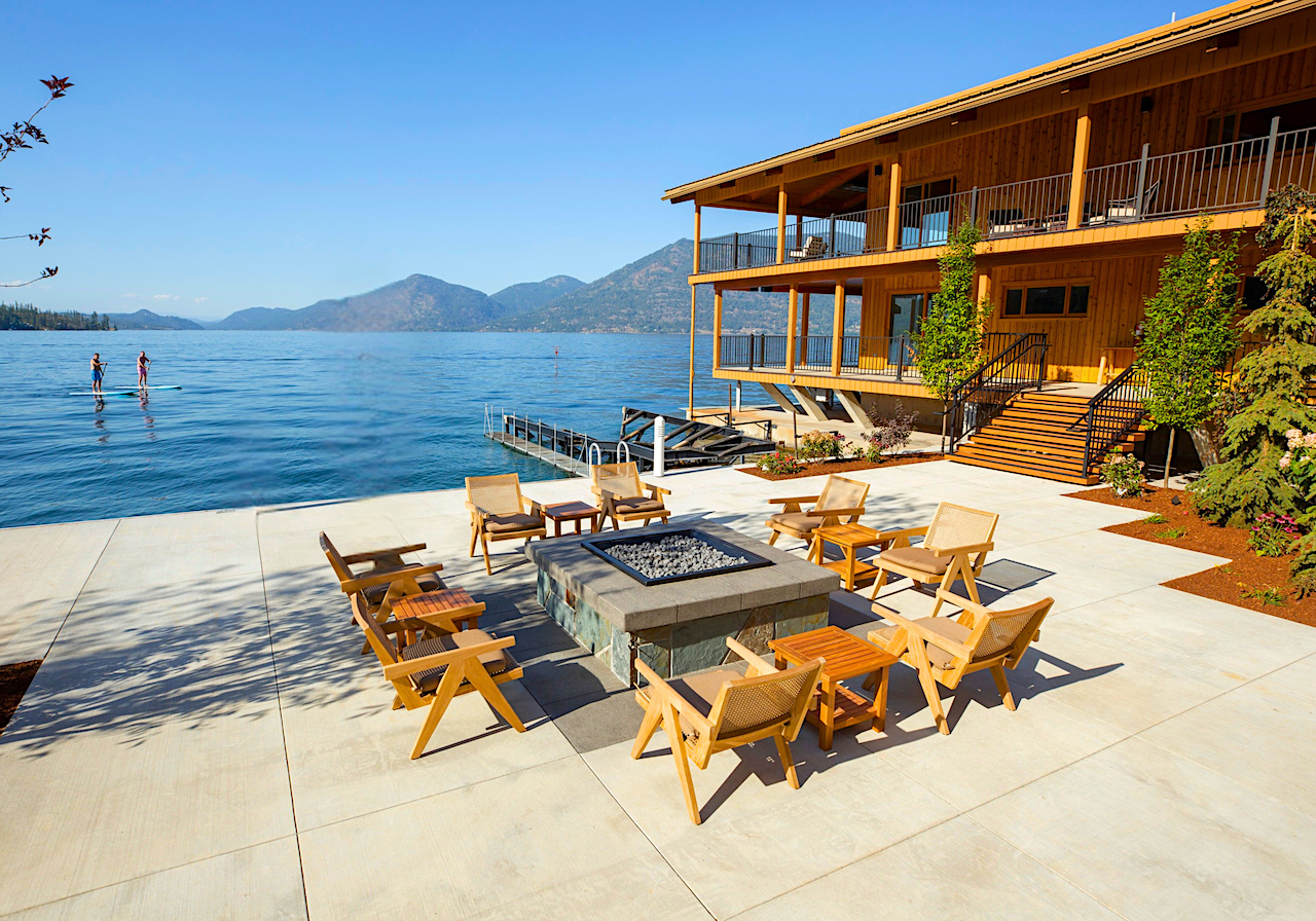 Wooden chairs around the lakeside fire pit at The Retreat on Lake Pend Oreille