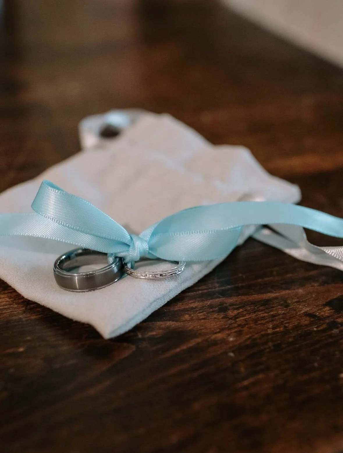 Wedding bands on a ribbon-tied pouch at a private wedding at The Retreat on Lake Pend Oreille