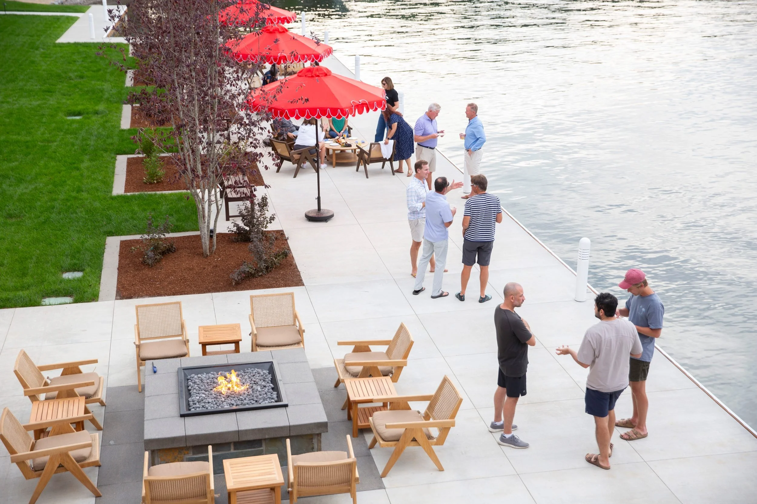 Guests socializing on the lakefront patio at The Retreat on Lake Pend Oreille in Sagle, Idaho