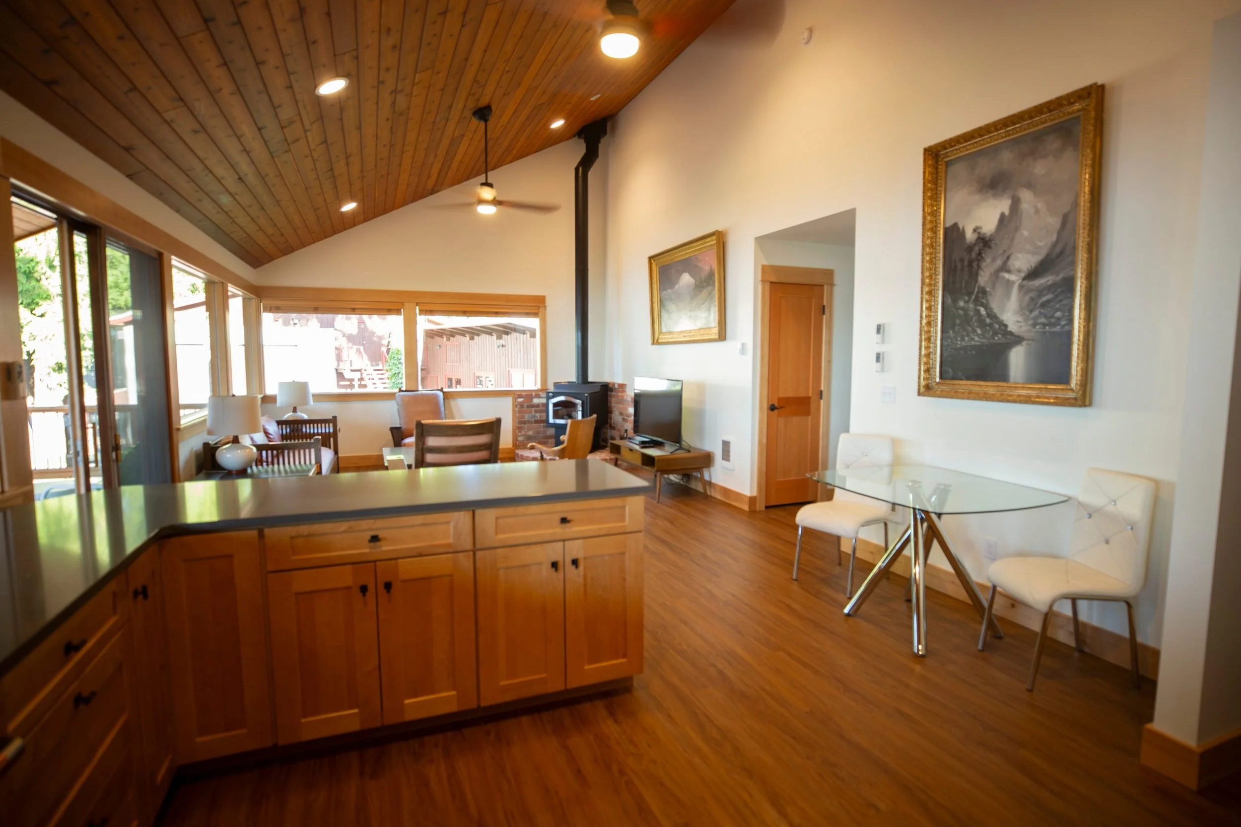 Open-concept cabin living room with a wood ceiling at The Retreat on Lake Pend Oreille