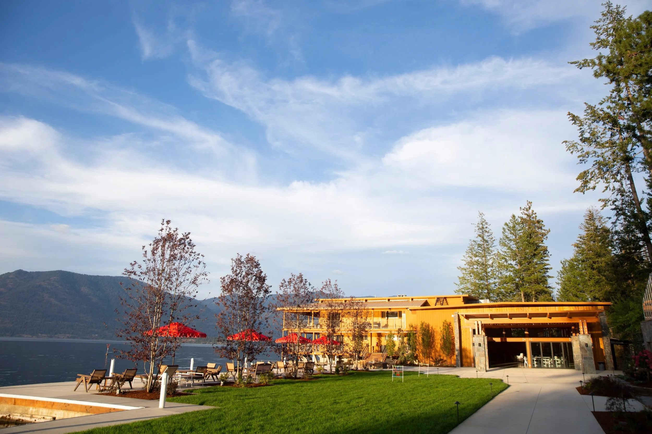 Lounge chairs and umbrellas on the lakeside patio at The Retreat on Lake Pend Oreille