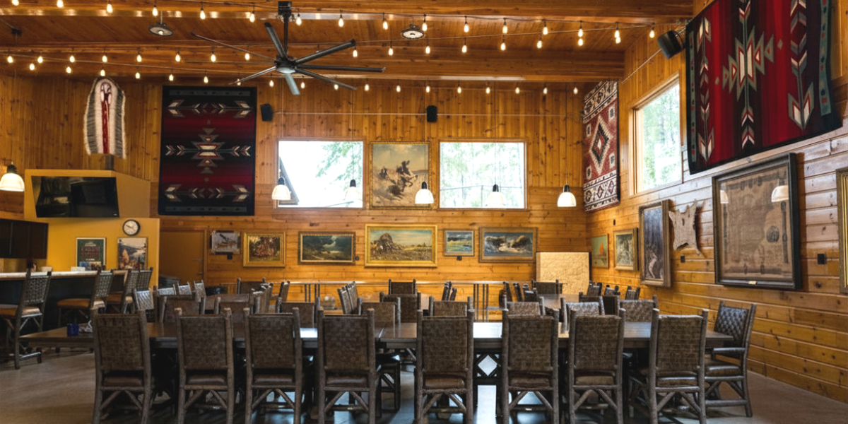 The Hangar dining hall under string lights at The Retreat on Lake Pend Oreille