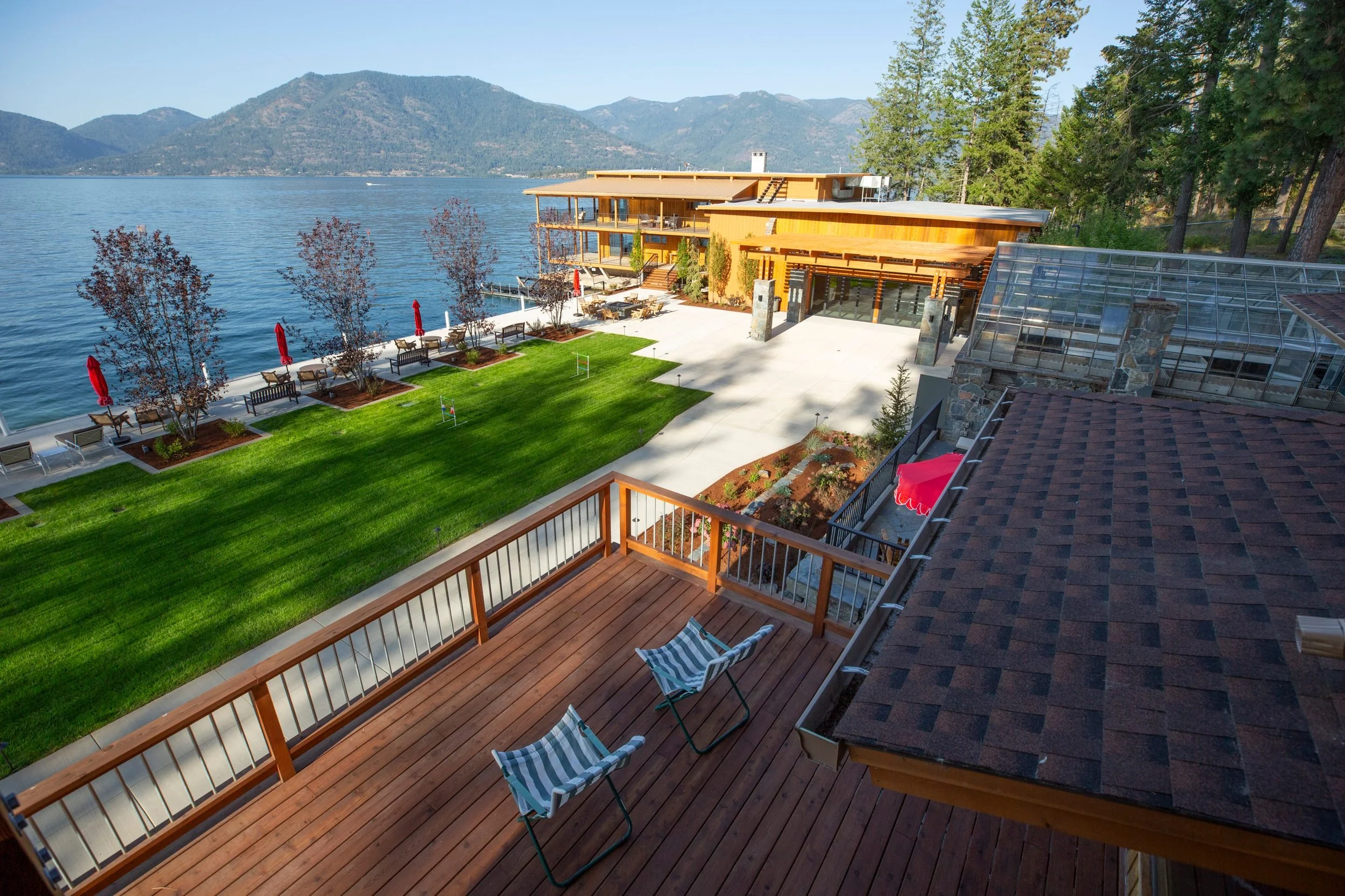 The lakeside deck and lawn at The Retreat on Lake Pend Oreille in Sagle, Idaho