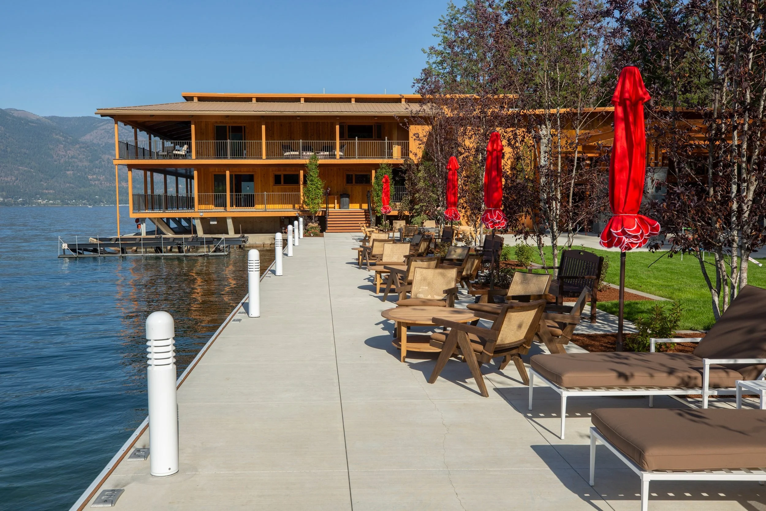 The lakeside patio with red umbrellas at The Retreat on Lake Pend Oreille in Sagle, Idaho