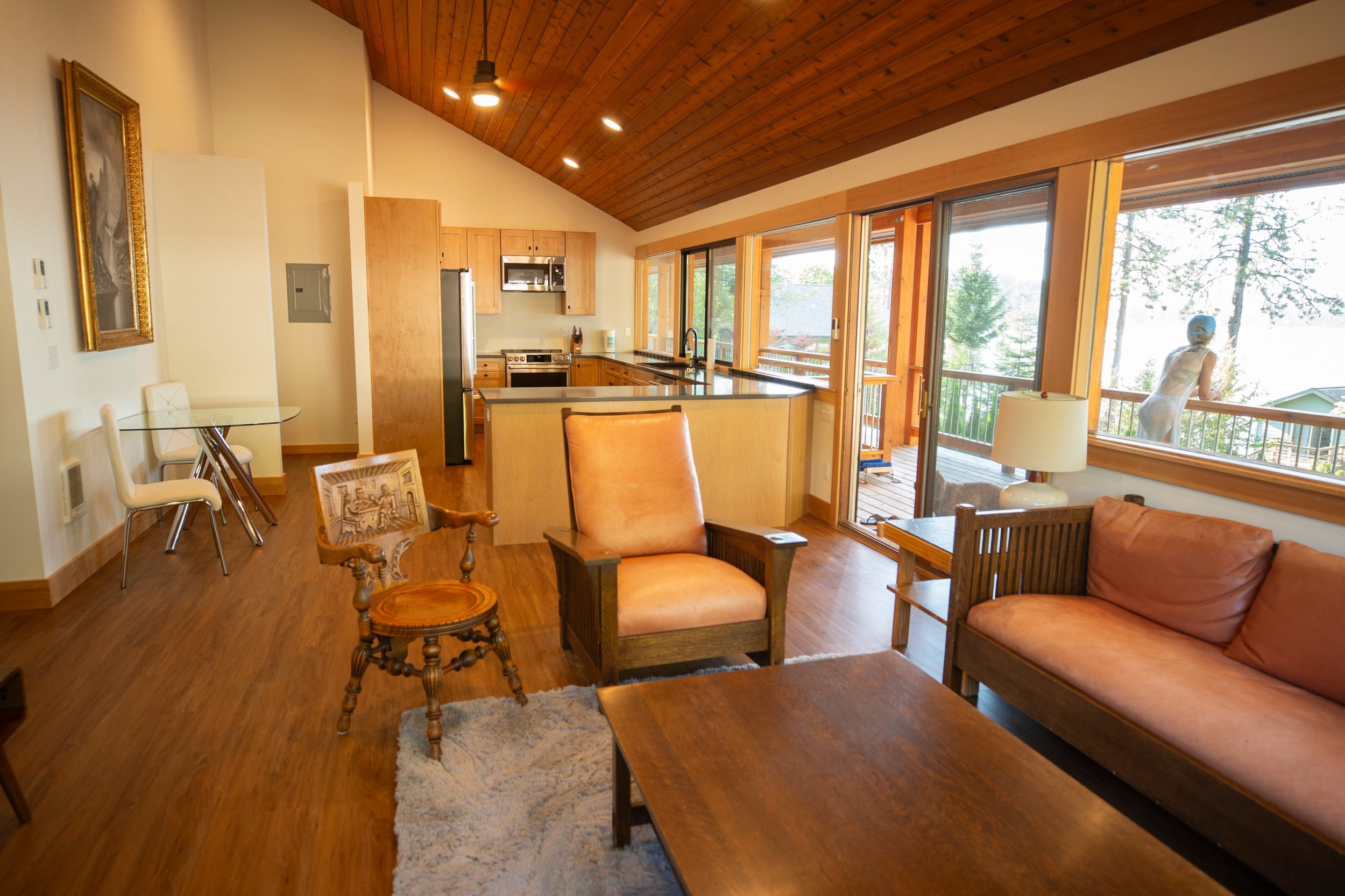 Cabin living room and kitchen with sliding doors at The Retreat on Lake Pend Oreille in Sagle, Idaho
