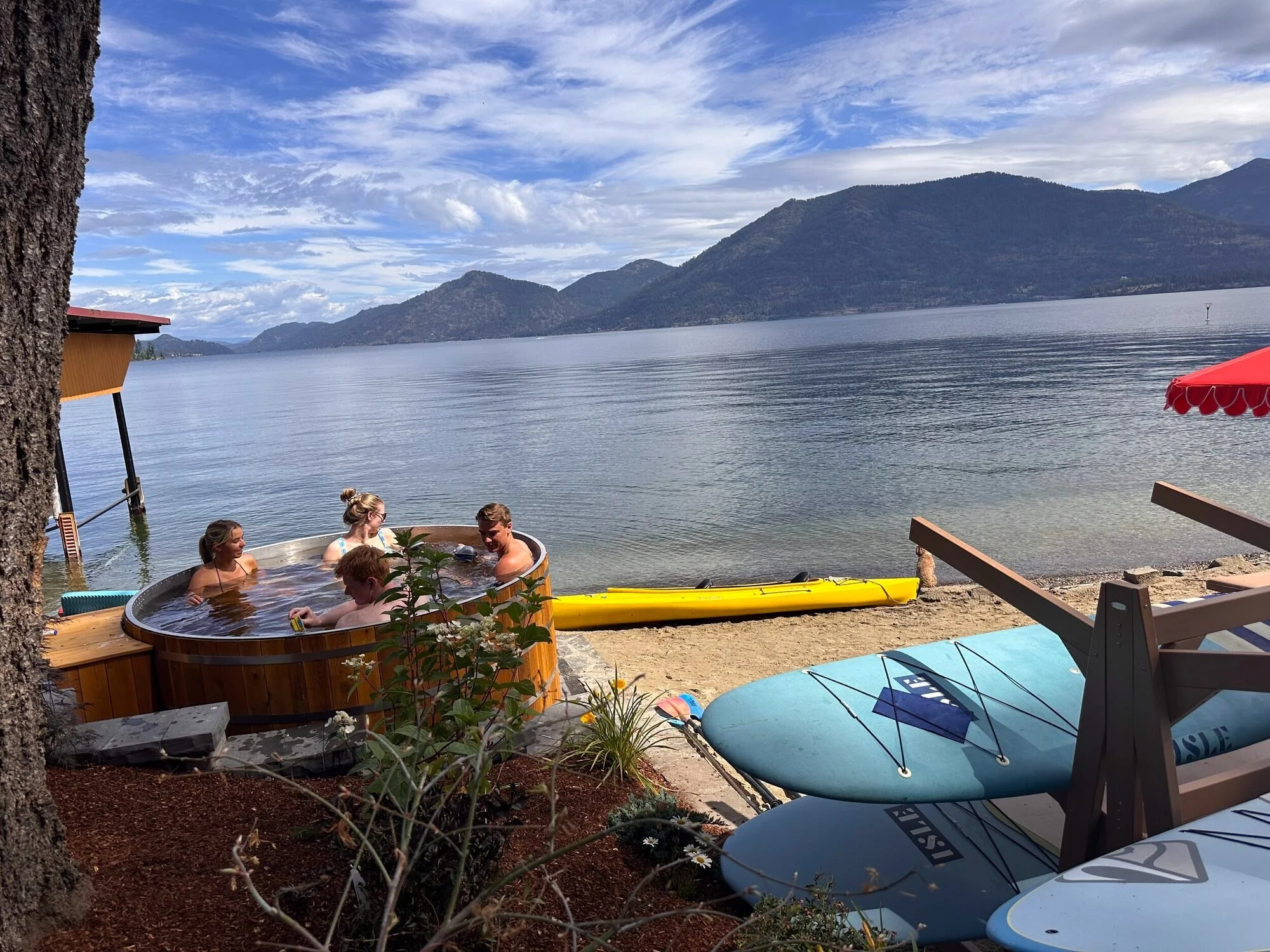 Guests relaxing in the hot tub beside Lake Pend Oreille in Sagle, Idaho