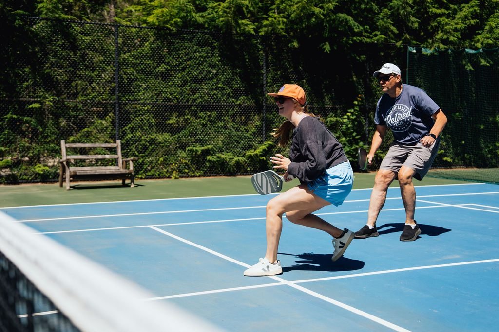 Two guests playing pickleball at The Retreat on Lake Pend Oreille in Sagle, Idaho
