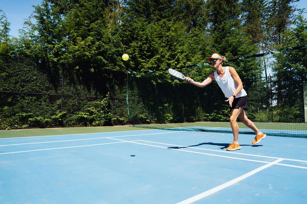 A guest returning a shot on the pickleball court at The Retreat on Lake Pend Oreille