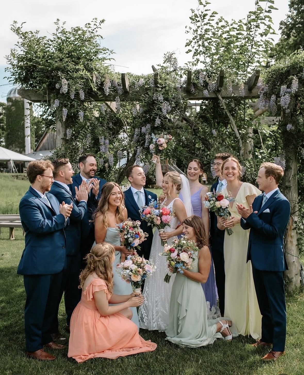 Wedding ceremony under the flowered arbor on the lawn at The Retreat on Lake Pend Oreille in Sagle, Idaho