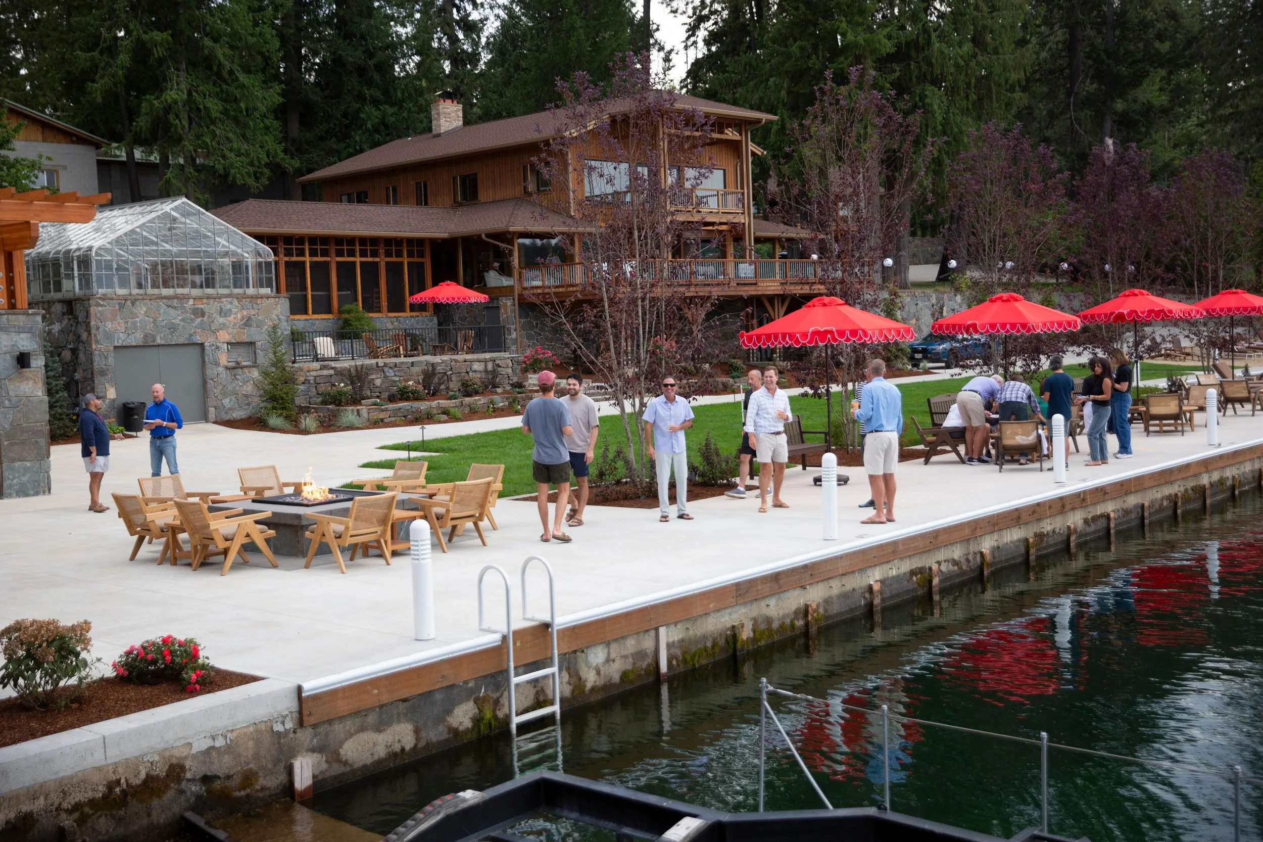 Guests gathered by the fire pit outside the lodge at The Retreat on Lake Pend Oreille
