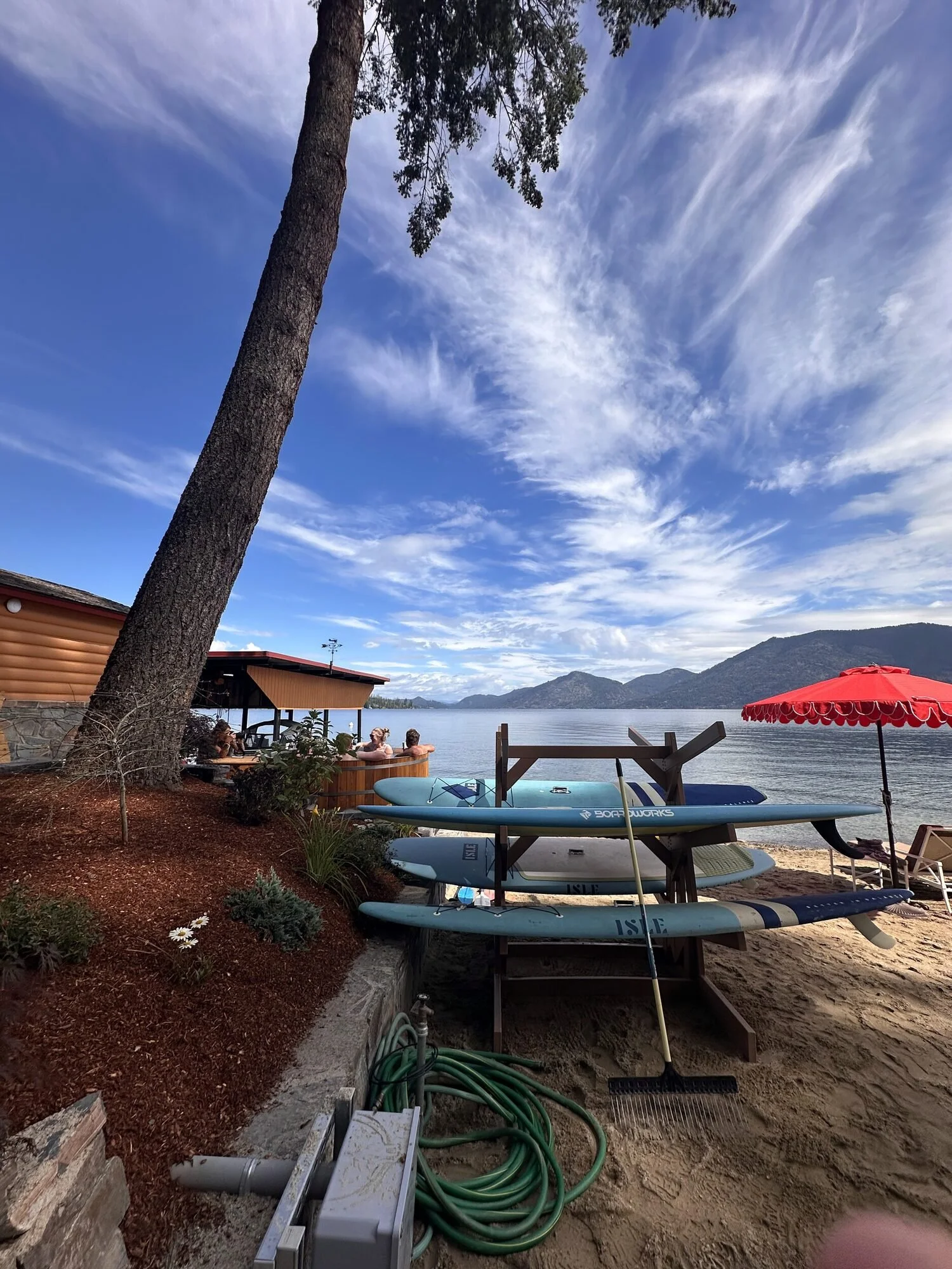 Paddleboards and kayaks on the beach at The Retreat on Lake Pend Oreille in Sagle, Idaho