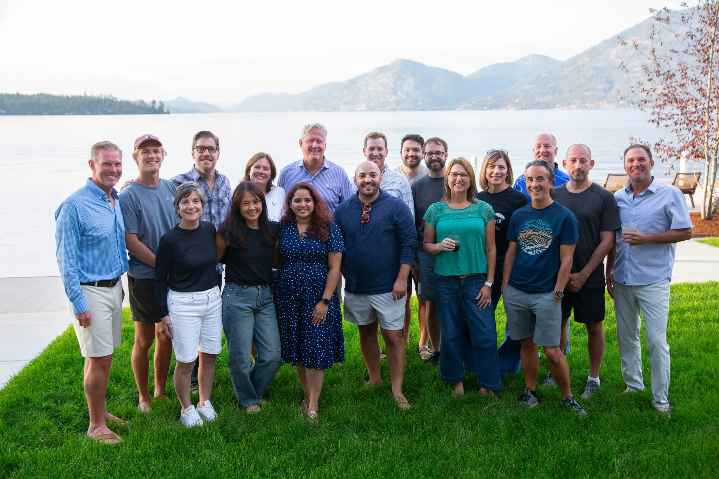 A group of fifteen guests on the lawn above Lake Pend Oreille in Sagle, Idaho