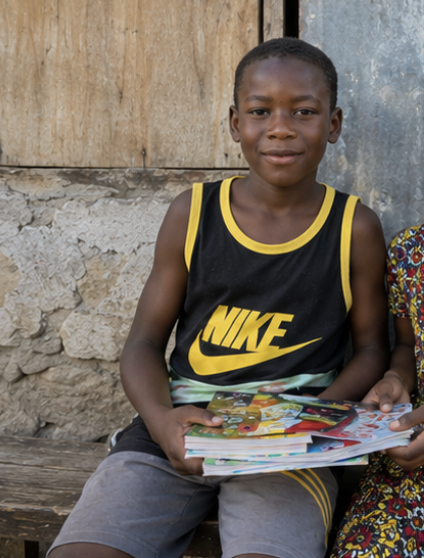 Jamaican boy holding books