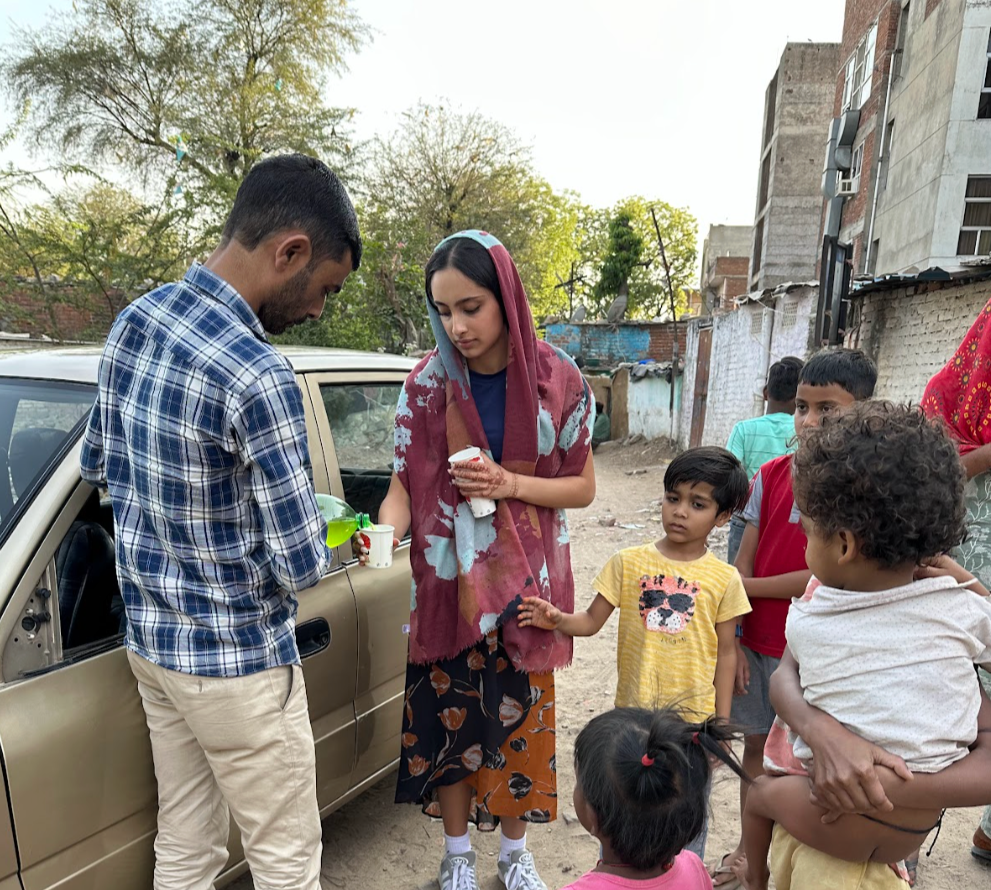 Girl helping homeless children in India