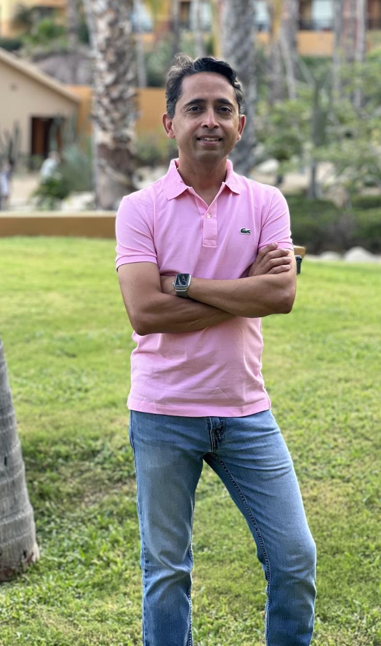 Indian man standing with hands crossed