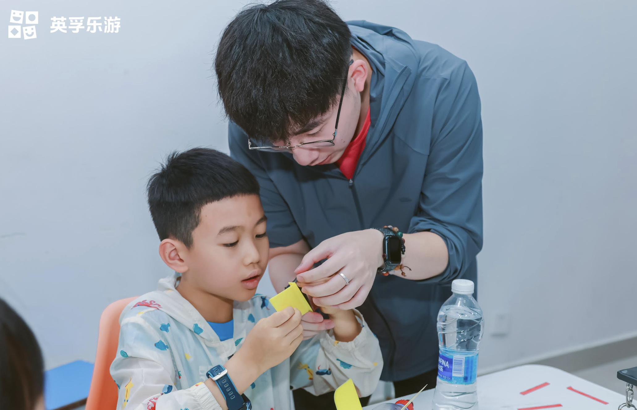 Chinese man helping small kid