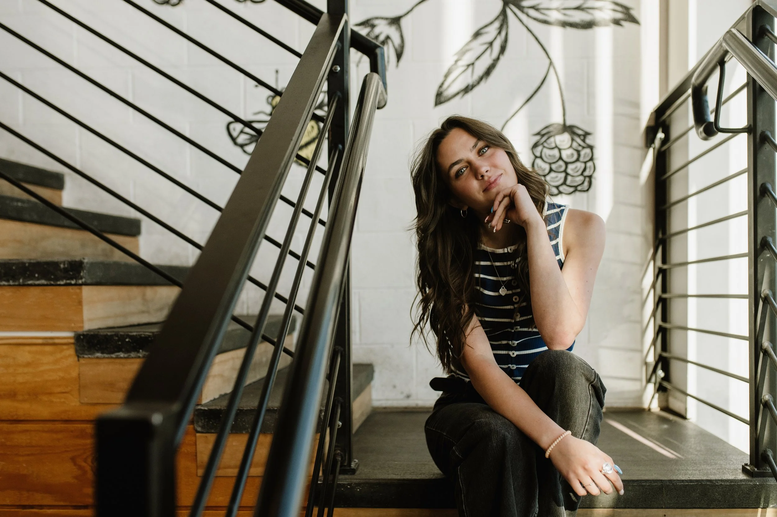 Senior sitting on stairs in Black Smith Ice cream in Millcreek, Utah
