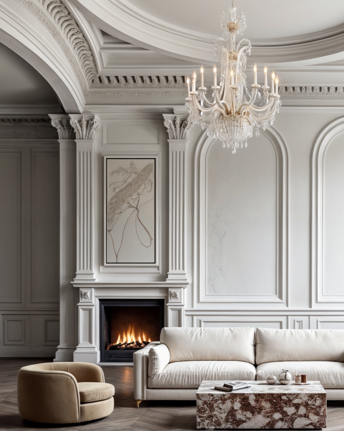 Elegant living room with white walls, ornate crown molding, a chandelier, a fireplace with a fire, and modern furniture including a white sofa, beige armchair, and marble coffee table.