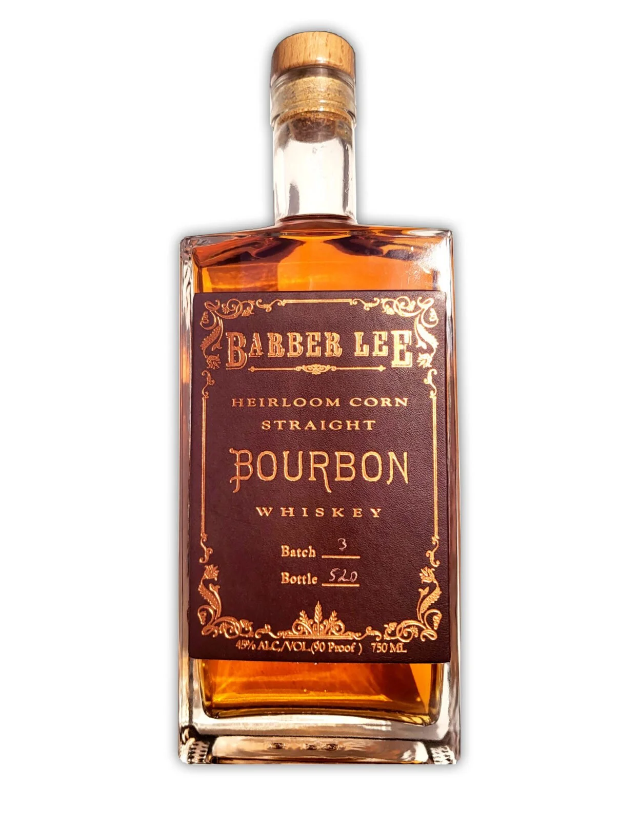 A bottle of Barber Lee heirloom corn straight bourbon whiskey with a dark purple label and gold decorative accents.