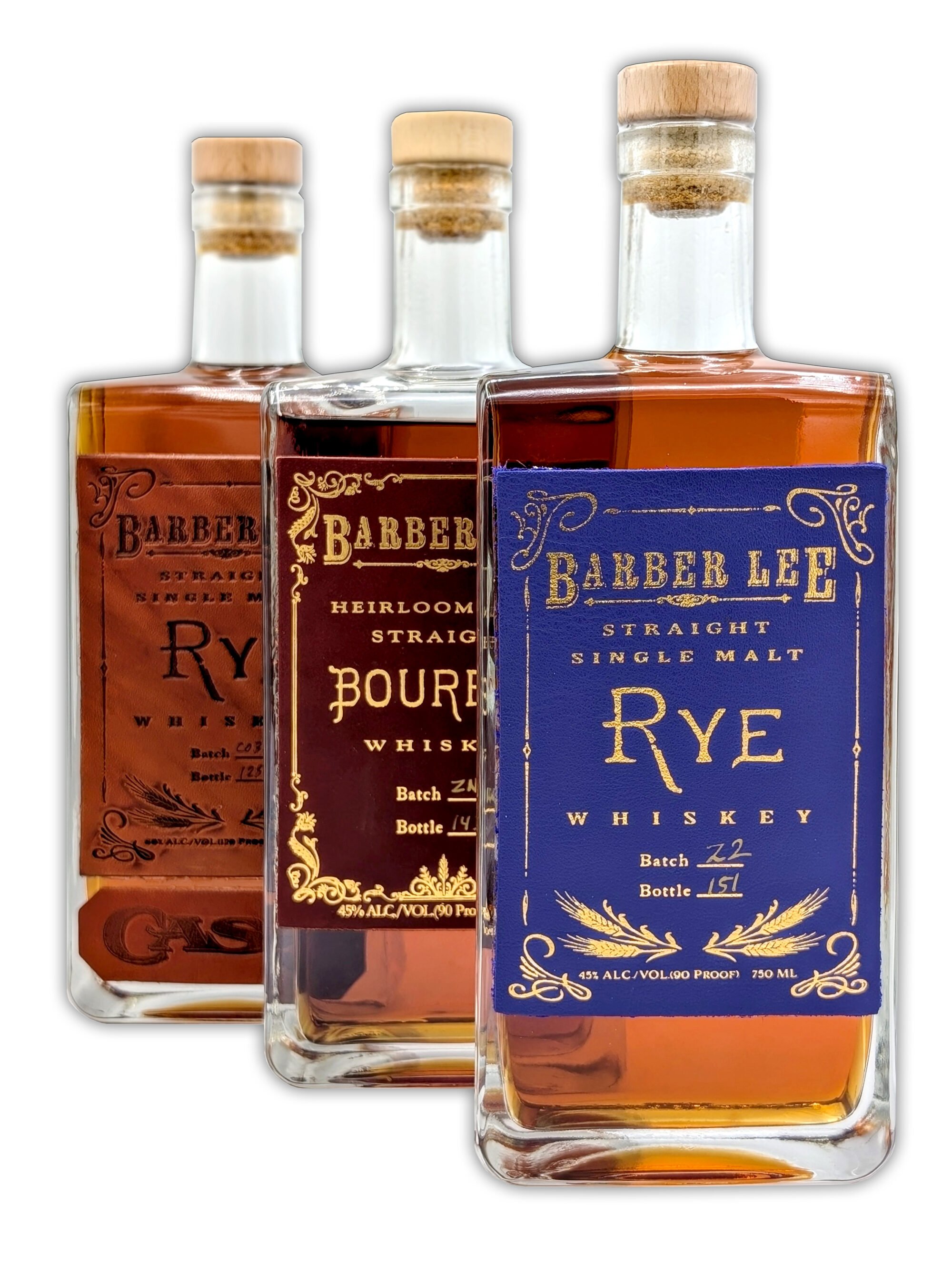Three bottles of whiskey with vintage-style labels, featuring orange and blue designs.